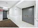 Building hallway with carpet, a door, and fire alarm at 220 Belleview Blvd # 609, Belleair, FL 33756