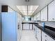 Kitchen with white cabinets, black countertops, and modern appliances at 220 Belleview Blvd # 609, Belleair, FL 33756