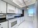 Kitchen with white cabinets, black countertops, and modern appliances at 220 Belleview Blvd # 609, Belleair, FL 33756