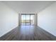 Bright living room featuring hardwood floors and sliding glass doors at 220 Belleview Blvd # 609, Belleair, FL 33756