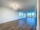 Spacious living room featuring hardwood floors and large windows at 220 Belleview Blvd # 609, Belleair, FL 33756
