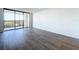 Spacious living room with hardwood floors and balcony access at 220 Belleview Blvd # 609, Belleair, FL 33756