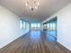 Spacious living room featuring hardwood floors and large windows at 220 Belleview Blvd # 609, Belleair, FL 33756