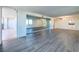 Living room with hardwood floors, balcony access, and mirrored wall at 220 Belleview Blvd # 609, Belleair, FL 33756