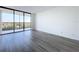 Spacious living room with hardwood floors and balcony access at 220 Belleview Blvd # 609, Belleair, FL 33756