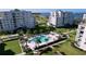 Community pool with spa and tropical landscaping at 220 Belleview Blvd # 609, Belleair, FL 33756