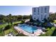 Resort-style pool with lounge chairs and landscaping at 220 Belleview Blvd # 609, Belleair, FL 33756