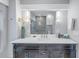 Modern bathroom with dark vanity, white countertop, and large mirror at 236 9Th Ne Ave, St Petersburg, FL 33701