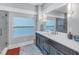Bathroom with dark vanity, marble floors, and a large shower at 236 9Th Ne Ave, St Petersburg, FL 33701