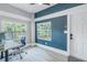 Bright home office with built-in desk and blue accent wall at 236 9Th Ne Ave, St Petersburg, FL 33701