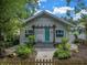 Quaint house exterior with teal door and landscaped yard at 236 9Th Ne Ave, St Petersburg, FL 33701