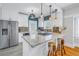 Updated kitchen boasts white cabinets, granite countertops, and a breakfast bar at 236 9Th Ne Ave, St Petersburg, FL 33701