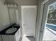 Small bathroom with vanity, single sink, and door to the outside at 3040 Sheppards Crook Ct, Holiday, FL 34691