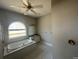 Bathroom features a large garden tub, vanity, and tile flooring at 3040 Sheppards Crook Ct, Holiday, FL 34691