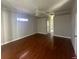 Spacious bedroom with hardwood floors and access to a bathroom at 3040 Sheppards Crook Ct, Holiday, FL 34691