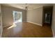 Bright bedroom with hardwood floors and sliding glass doors to the pool area at 3040 Sheppards Crook Ct, Holiday, FL 34691