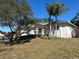 White single story house with palm trees and lush landscaping at 3040 Sheppards Crook Ct, Holiday, FL 34691