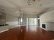 Large living room with hardwood floors, fireplace, and pool view at 3040 Sheppards Crook Ct, Holiday, FL 34691