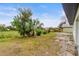 Backyard view of property with a pond and lush greenery at 3145 Covina St, New Port Richey, FL 34655