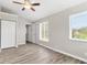 Spacious bedroom with wood-look flooring and ceiling fan at 3145 Covina St, New Port Richey, FL 34655