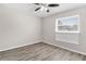 Well-lit bedroom with wood-look flooring and ceiling fan at 3145 Covina St, New Port Richey, FL 34655