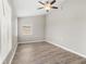 Spacious bedroom with wood-look floors and ceiling fan at 3145 Covina St, New Port Richey, FL 34655