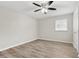 Bright bedroom with wood-look flooring and a window at 3145 Covina St, New Port Richey, FL 34655