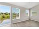 Bright bonus room with backyard access and wood-look floors at 3145 Covina St, New Port Richey, FL 34655