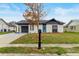 Newly renovated house with gray accents and a blue door at 3145 Covina St, New Port Richey, FL 34655