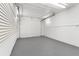 Spacious garage interior with painted walls and gray flooring at 3145 Covina St, New Port Richey, FL 34655