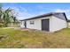 Newly constructed detached garage with dark gray door at 3145 Covina St, New Port Richey, FL 34655