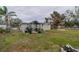 Large backyard with covered patio and fire pit at 3645 Lokai Pl, Sarasota, FL 34232