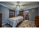 Main bedroom with wood frame bed and large closet at 3645 Lokai Pl, Sarasota, FL 34232