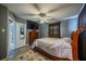 Bedroom with wood frame bed and large TV at 3645 Lokai Pl, Sarasota, FL 34232