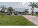 Cute bungalow with brick paver driveway and well-manicured lawn at 3645 Lokai Pl, Sarasota, FL 34232