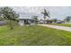 Charming gray house with a spacious lawn and brick driveway at 3645 Lokai Pl, Sarasota, FL 34232