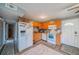 Galley kitchen with wood cabinets and white appliances at 3645 Lokai Pl, Sarasota, FL 34232