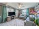 Cozy living room featuring a sectional sofa and large TV at 3645 Lokai Pl, Sarasota, FL 34232