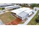 Aerial view of a white mobile home with a carport and a red driveway at 37318 Lois Ave, Zephyrhills, FL 33542