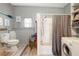 Bathroom features a shower/tub combo and laundry area at 37318 Lois Ave, Zephyrhills, FL 33542