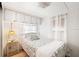 Charming bedroom with a full-size bed and overhead cabinets at 37318 Lois Ave, Zephyrhills, FL 33542