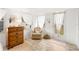Serene bedroom with a dresser and comfortable seating area at 37318 Lois Ave, Zephyrhills, FL 33542