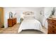 Cozy bedroom with a comfortable bed and wood furniture at 37318 Lois Ave, Zephyrhills, FL 33542