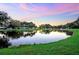 Serene community lake at sunset at 37318 Lois Ave, Zephyrhills, FL 33542