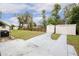 Home exterior with two storage sheds and yard at 37318 Lois Ave, Zephyrhills, FL 33542