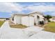 White single-wide home with shed and paved driveway at 37318 Lois Ave, Zephyrhills, FL 33542