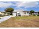 Front view of a white single-wide home at 37318 Lois Ave, Zephyrhills, FL 33542