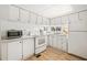 Bright kitchen with white cabinets, new flooring, and modern appliances at 37318 Lois Ave, Zephyrhills, FL 33542