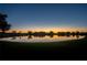 Peaceful lakefront community at sunset, reflecting homes and trees at 37318 Lois Ave, Zephyrhills, FL 33542