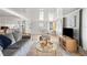 Open living room with gray sofa and kitchen view at 37318 Lois Ave, Zephyrhills, FL 33542